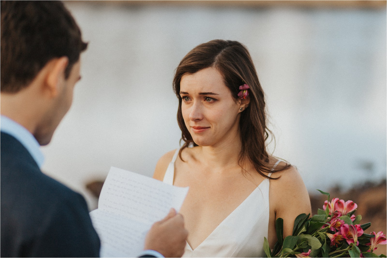Emotional bride listening to her groom's vows to his bride during their elopement in Colorado.