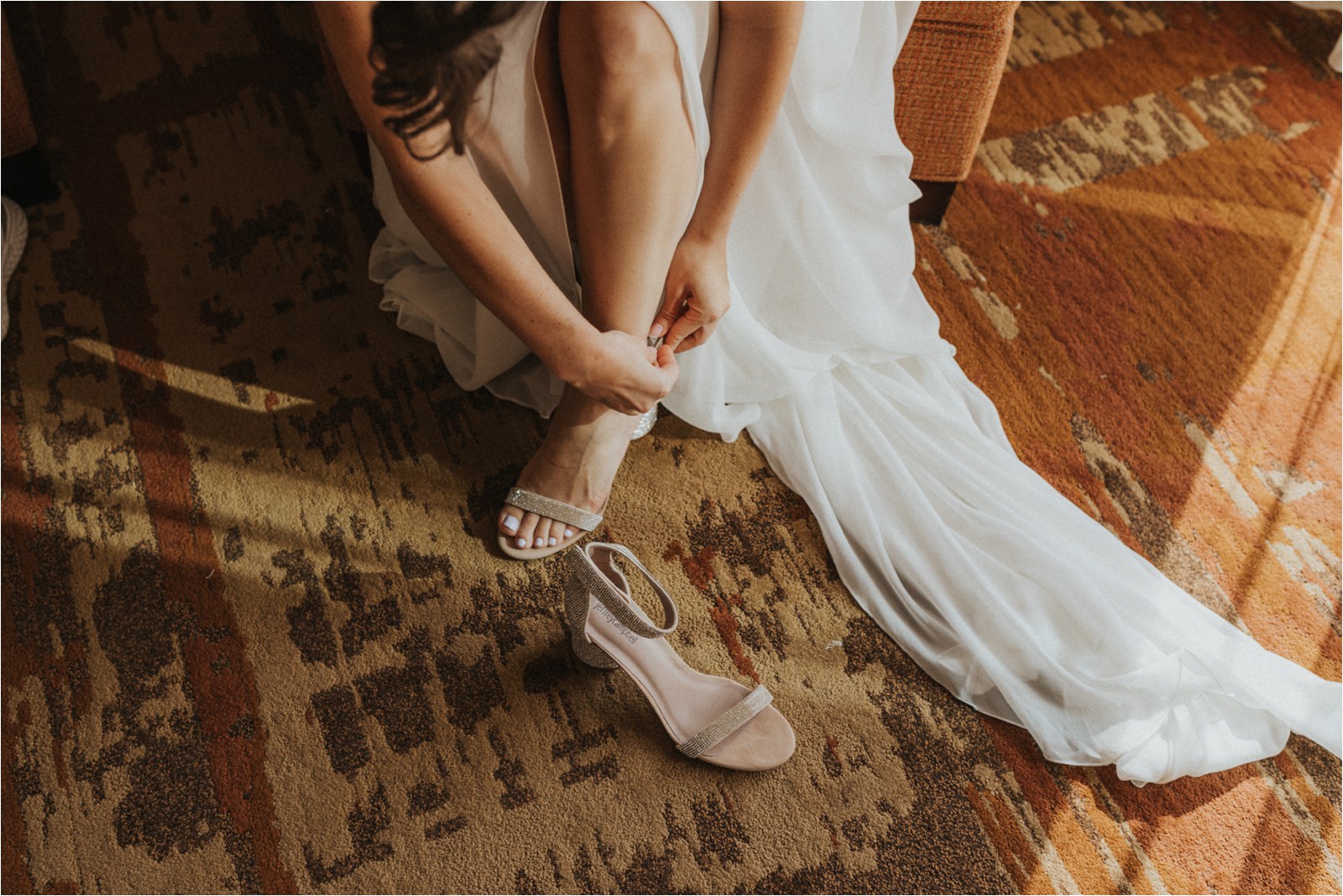 Erin, the bride, getting her shoes on and getting ready for her first look with her groom, Harry.